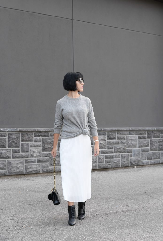 Pleats Are Back, spring skirt, what to wear this spring, grey Cashmere Sweater, Aritzia sweater, Chanel Double Flap, Bulova watch, toms Sunglasses, white Pleated Skirt, Aritzia skirt, Vince Camuto booties, black booties