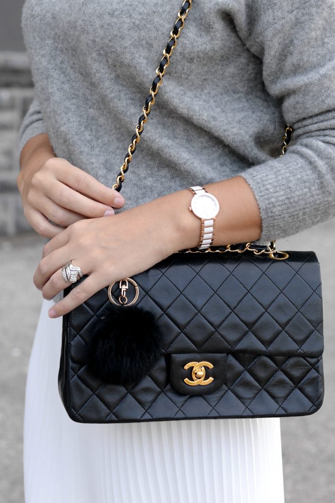 Pleats Are Back, spring skirt, what to wear this spring, grey Cashmere Sweater, Aritzia sweater, Chanel Double Flap, Bulova watch, toms Sunglasses, white Pleated Skirt, Aritzia skirt, Vince Camuto booties, black booties